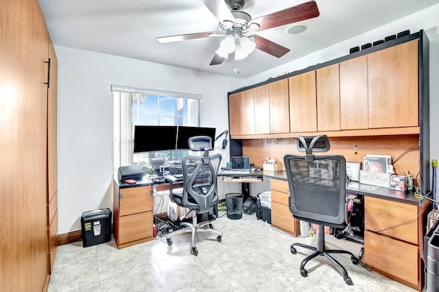 home office featuring ceiling fan and built in desk