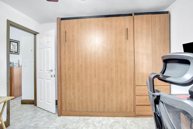 unfurnished office with light tile patterned floors