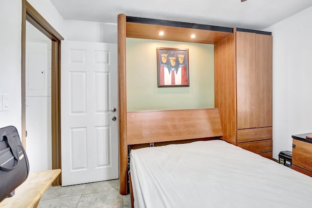 tiled bedroom with electric panel