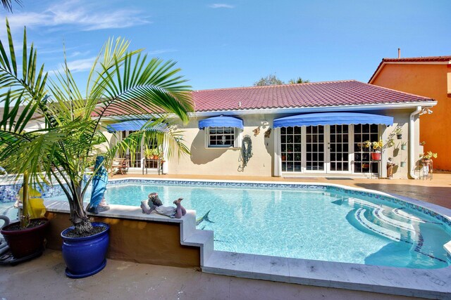 view of pool featuring a patio area and french doors