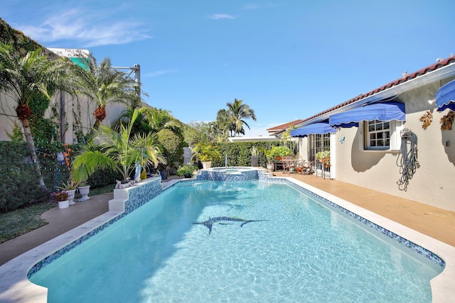 view of pool with an in ground hot tub and a patio area