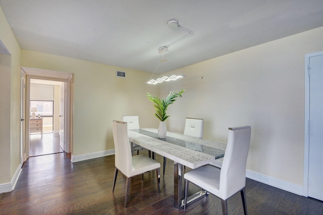 dining space with dark hardwood / wood-style flooring