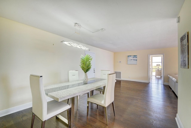 dining space with dark wood-type flooring