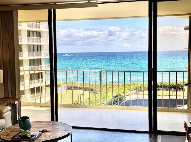 balcony featuring a water view and a beach view