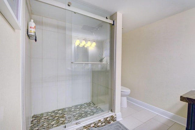 bathroom with tile patterned flooring, toilet, and walk in shower