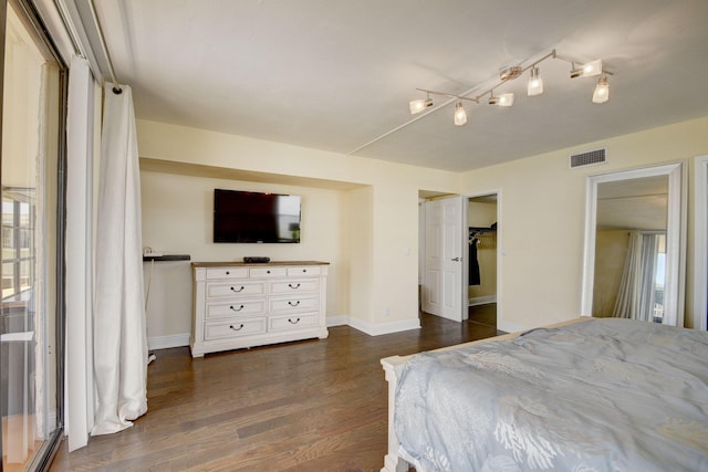 bedroom with dark wood-type flooring