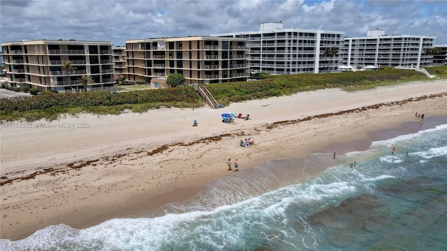 view of property featuring a view of the beach and a water view