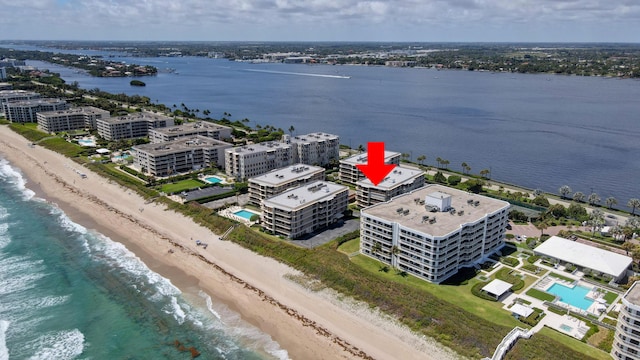 birds eye view of property with a view of the beach and a water view