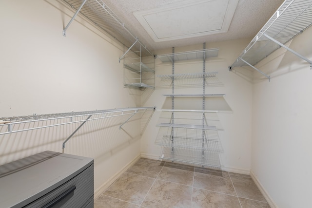 spacious closet featuring tile patterned floors