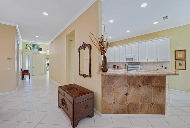 kitchen featuring light tile patterned floors, decorative backsplash, white cabinets, and white appliances