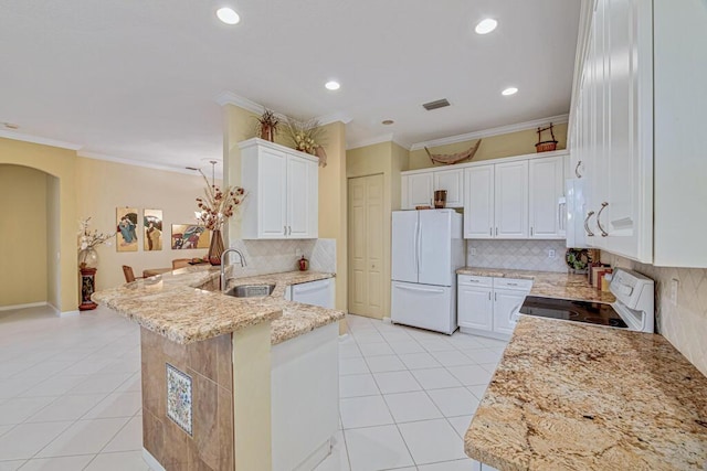 kitchen featuring light stone countertops, white cabinetry, kitchen peninsula, and white appliances