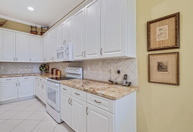 kitchen with white cabinets, backsplash, light tile patterned flooring, and white appliances