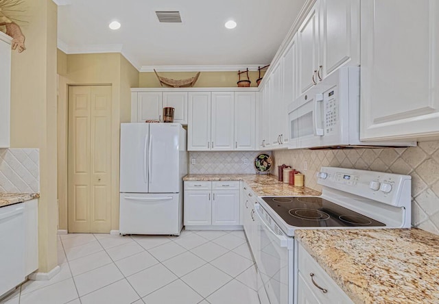 kitchen with light tile patterned flooring, crown molding, white appliances, light stone countertops, and white cabinets