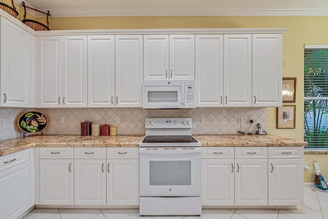 kitchen with light tile patterned floors, white cabinetry, tasteful backsplash, and white appliances