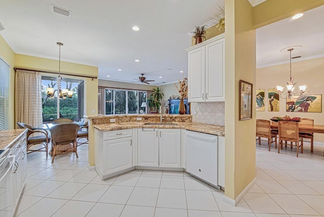 kitchen with white cabinets, kitchen peninsula, ceiling fan with notable chandelier, and white dishwasher