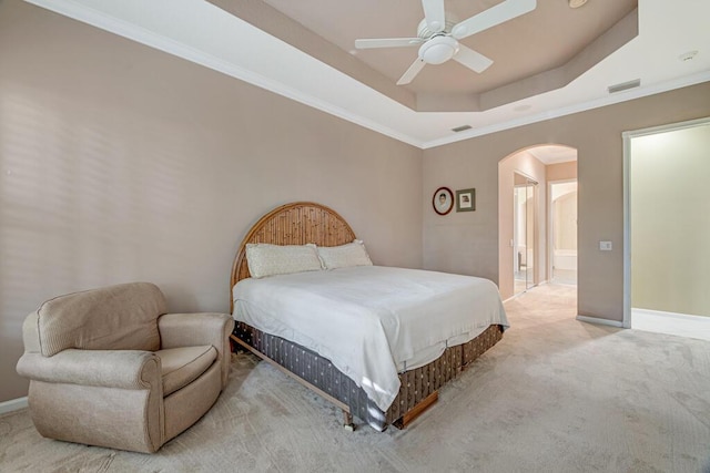 bedroom with ceiling fan, carpet, ornamental molding, and a tray ceiling