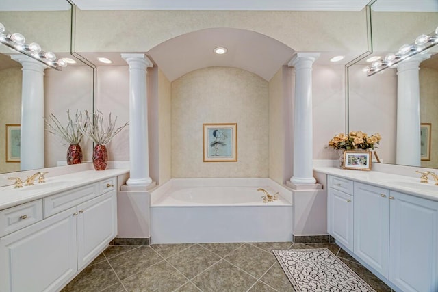 bathroom with vanity, tile patterned flooring, and a washtub