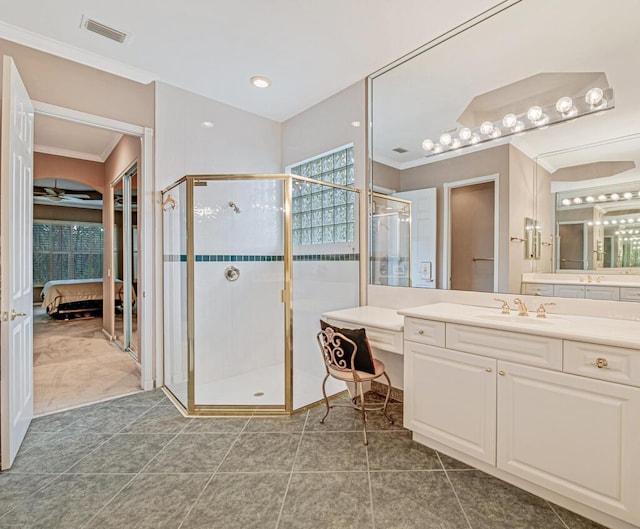 bathroom featuring ceiling fan, tile patterned flooring, a shower with shower door, and vanity