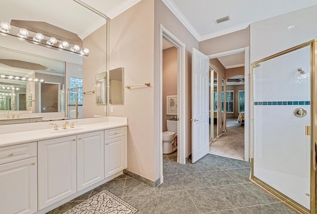 bathroom with tile patterned flooring, vanity, toilet, walk in shower, and ornamental molding