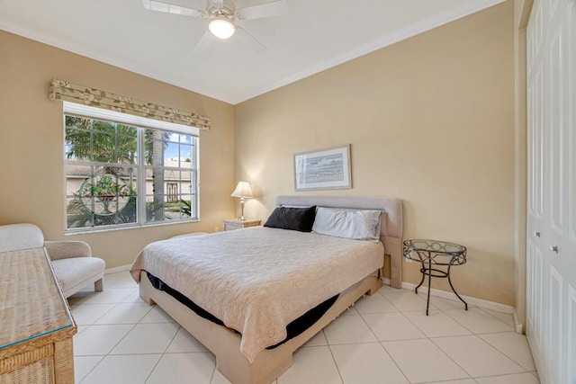 bedroom featuring ceiling fan, light tile patterned floors, and a closet