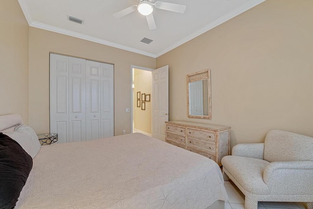 tiled bedroom featuring ceiling fan, a closet, and ornamental molding