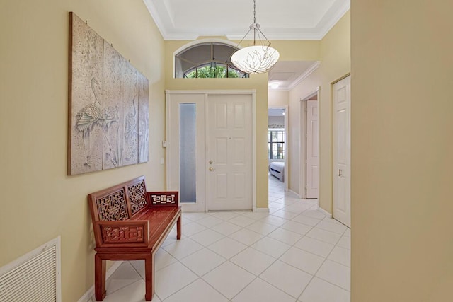 foyer entrance featuring ornamental molding and light tile patterned flooring