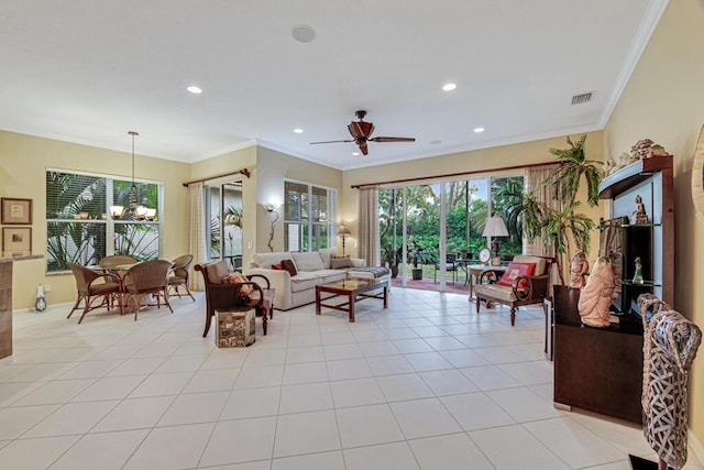 tiled living room with ceiling fan with notable chandelier and ornamental molding