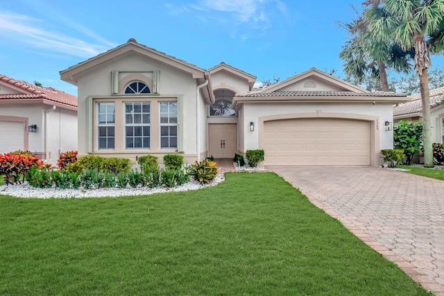 view of front of property featuring a garage and a front yard