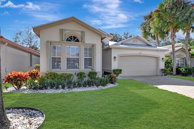 ranch-style home featuring a front yard and a garage