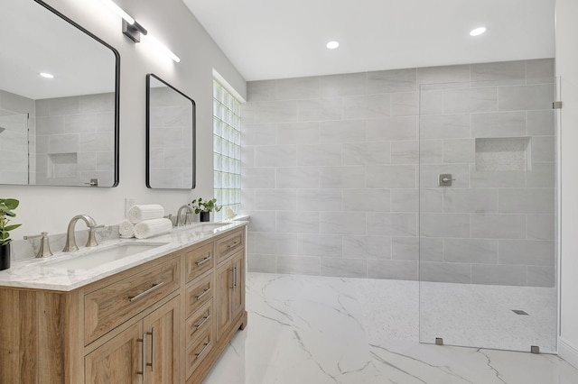 bathroom featuring a tile shower and vanity