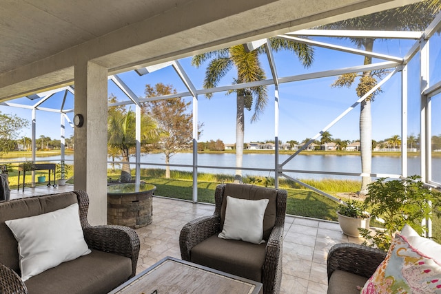 sunroom / solarium featuring a water view