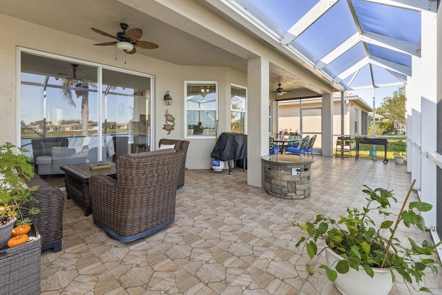 view of patio / terrace with ceiling fan and a lanai