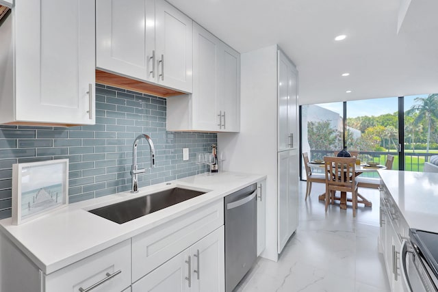 kitchen with appliances with stainless steel finishes, tasteful backsplash, white cabinetry, and sink