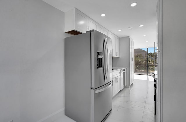 kitchen with white cabinetry, expansive windows, and appliances with stainless steel finishes