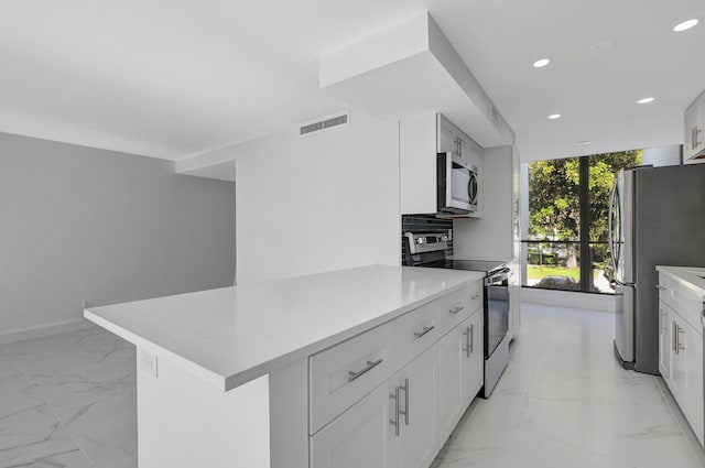 kitchen with white cabinets and appliances with stainless steel finishes