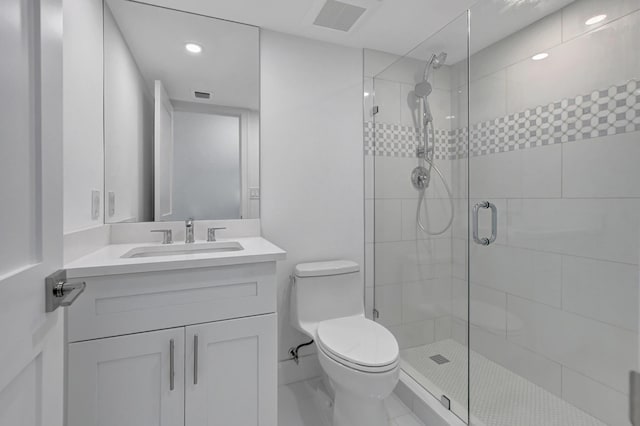 bathroom with vanity, toilet, and a shower with shower door