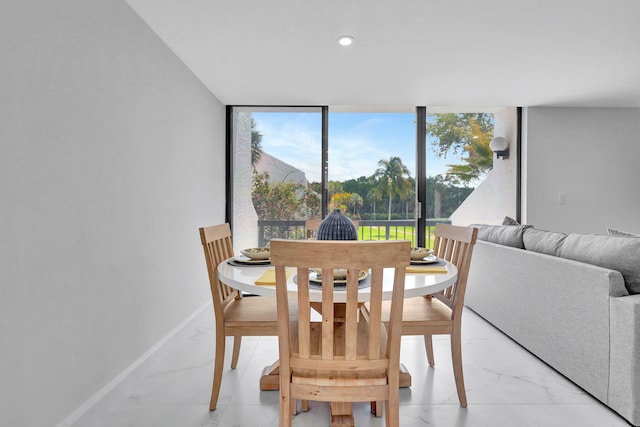 dining space featuring a wall of windows