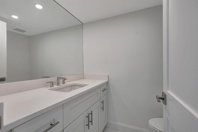 bathroom with vanity and toilet