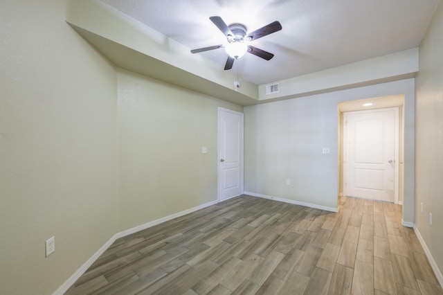 empty room featuring ceiling fan and light hardwood / wood-style flooring