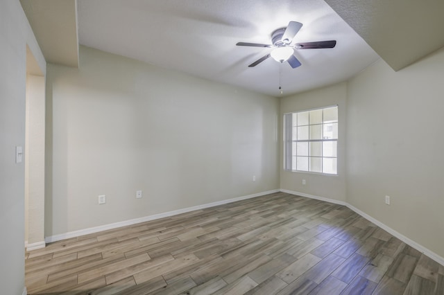 empty room featuring ceiling fan and light wood-type flooring