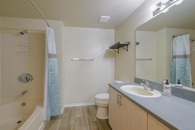 full bathroom with vanity, shower / bath combination with curtain, a textured ceiling, and toilet