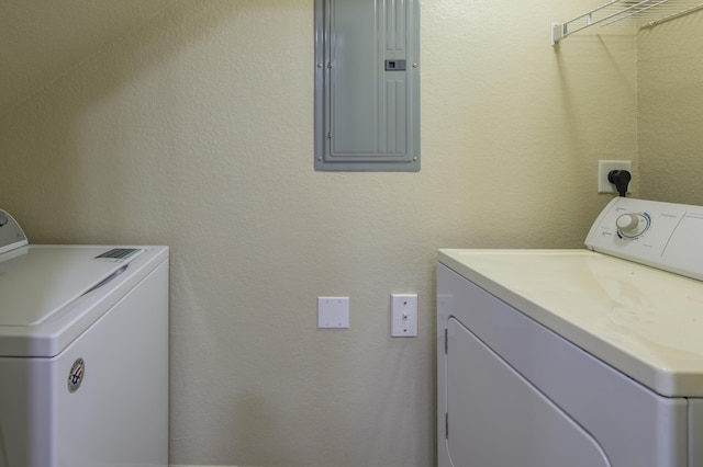 washroom with electric panel and washing machine and dryer