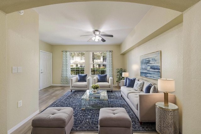 living room with ceiling fan and light hardwood / wood-style floors