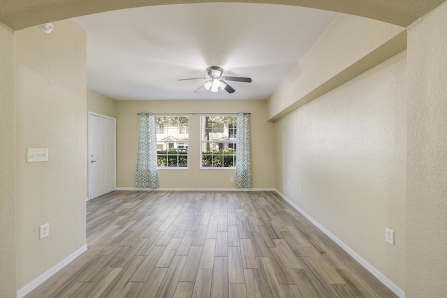 spare room featuring ceiling fan and light hardwood / wood-style floors