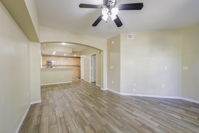 unfurnished living room with ceiling fan and light hardwood / wood-style floors