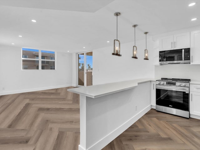 kitchen featuring kitchen peninsula, white cabinetry, stainless steel appliances, and parquet flooring