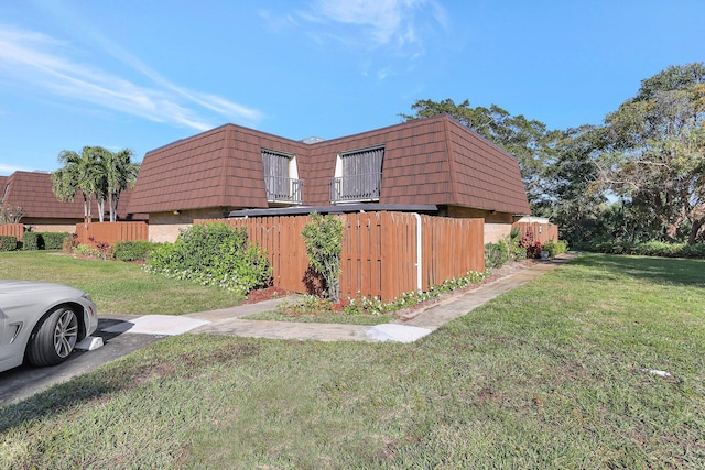 view of side of home featuring a yard