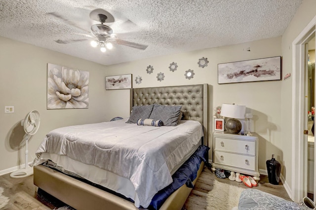 bedroom featuring ceiling fan, light hardwood / wood-style flooring, and a textured ceiling