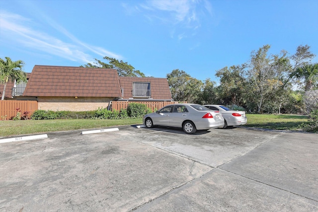 view of vehicle parking featuring a lawn