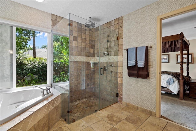 ensuite bathroom with a bath, a stall shower, a textured ceiling, wallpapered walls, and ensuite bathroom